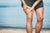 A man holding a his leg muscle